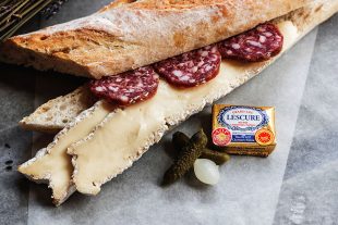 Image of baguette with cheese and salami, plus gherkins and French brand butter alongside