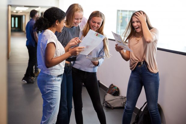 Four teenage girls collecting exam results