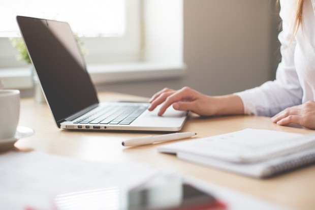 examiner typing on laptop