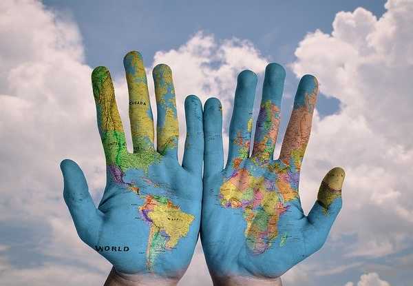 hands painted with map of world